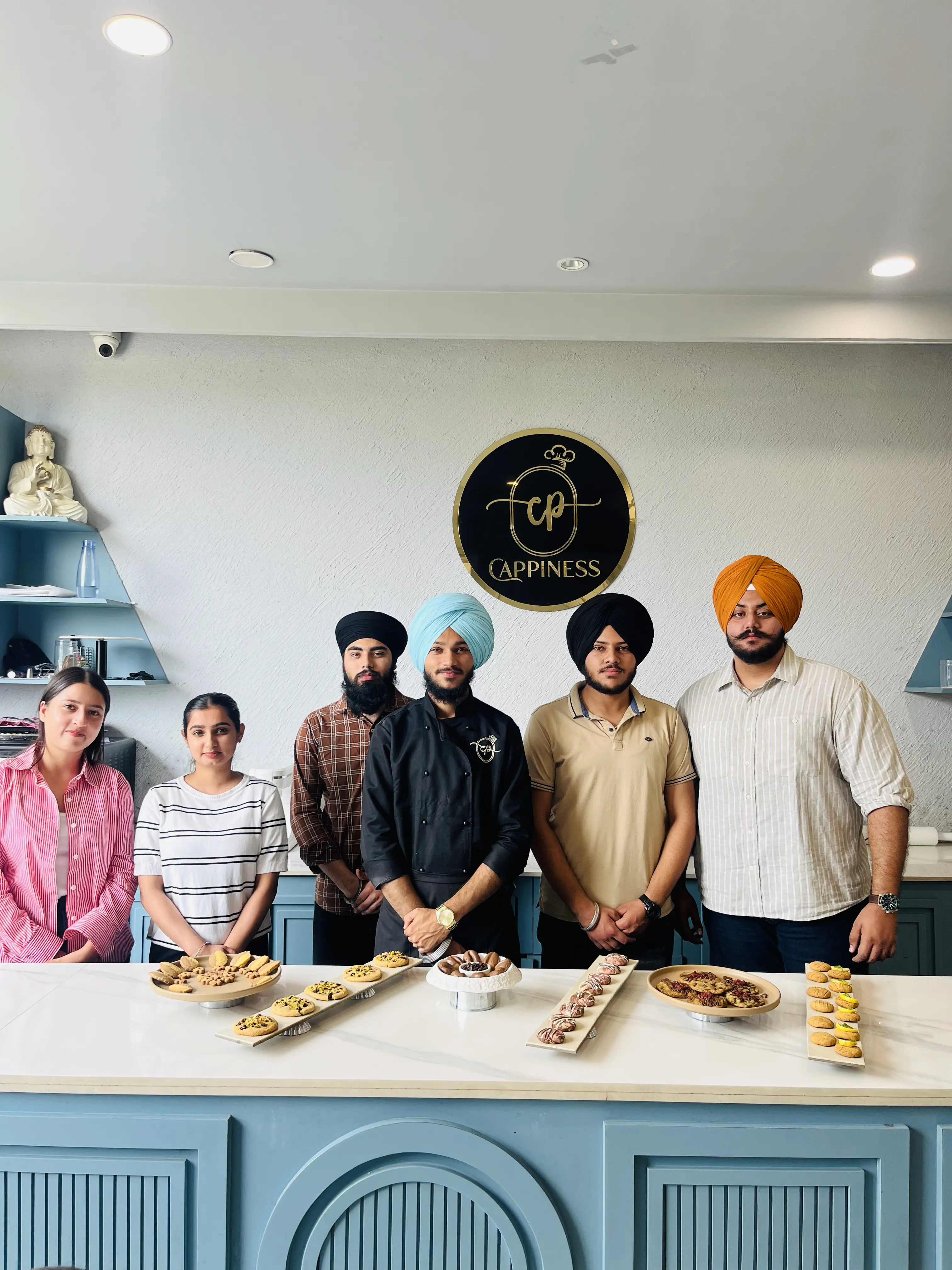 Students and instructors with a spread of plated bites at the studio counter