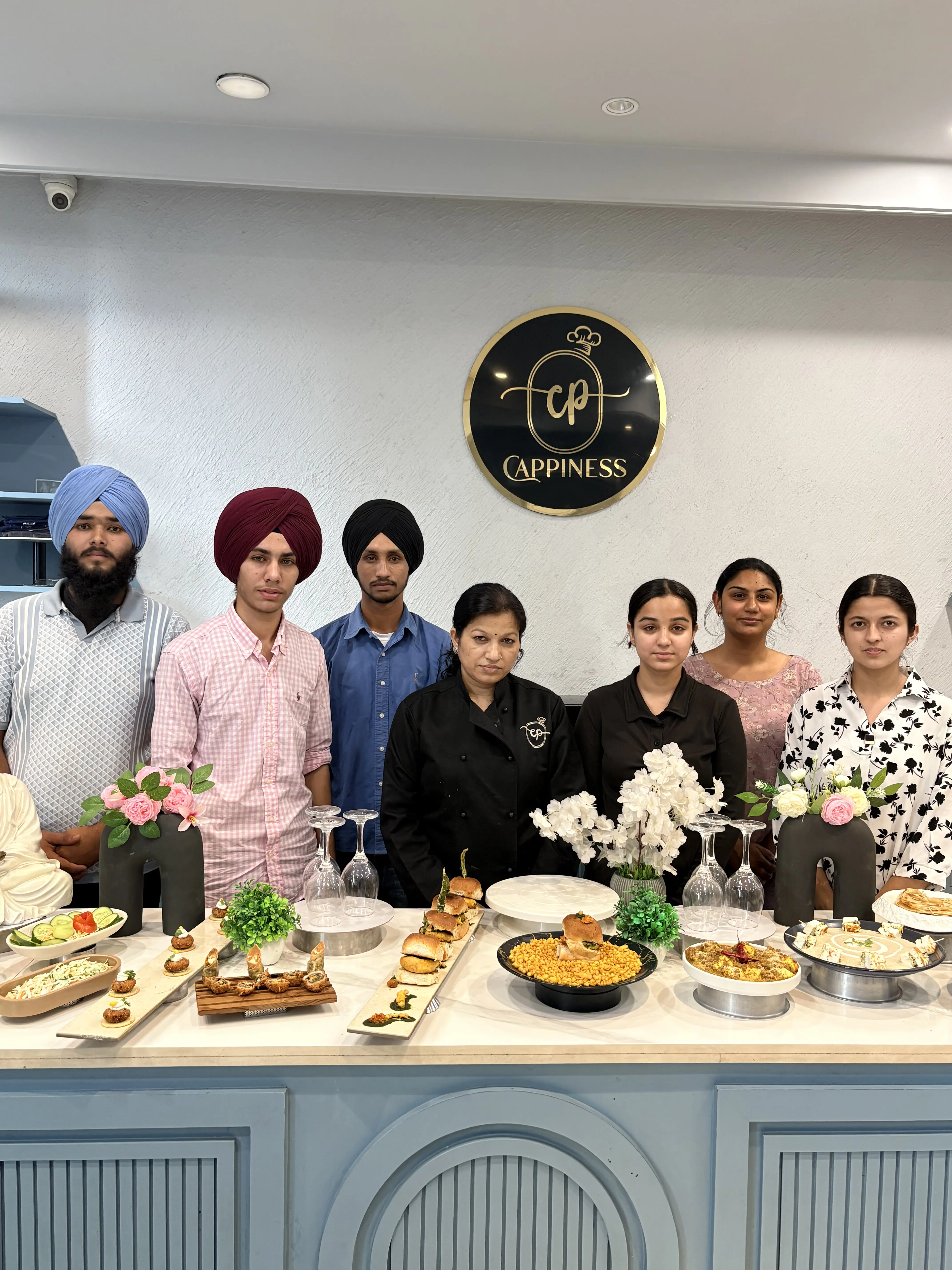 Students presenting Indian and continental dishes at the Cappiness counter